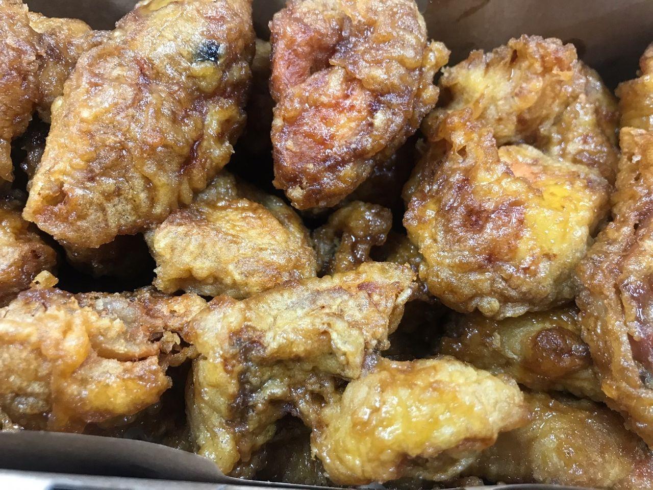 A close-up of crispy, golden Kyochon Honey Chicken pieces.